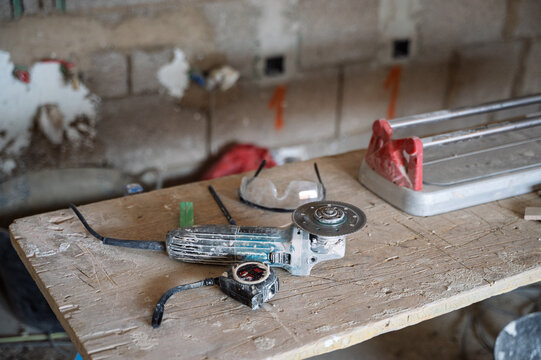 Construction tools on workbench with angle grinder &ndash; home renovation concept