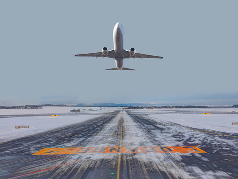 A passenger plane taking off from a foggy and icy runway - Norway