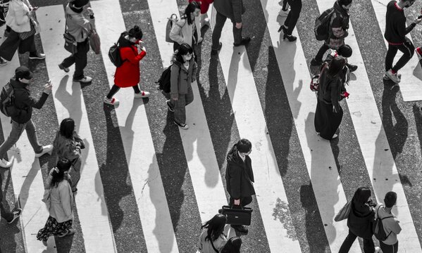 Single person in red, Shibuya crossing, crowds at intersection, many people cross zebra crossing, black and white, Shibuya, Udagawacho, Tokyo, Japan