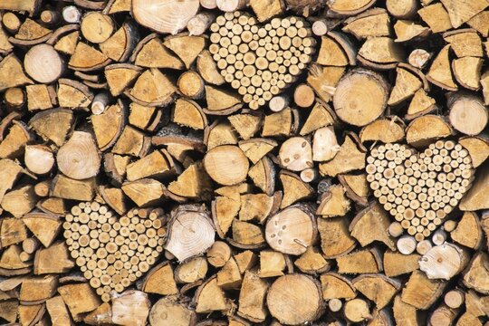 Pile of wood with wooden hearts, Tyrol, Austria