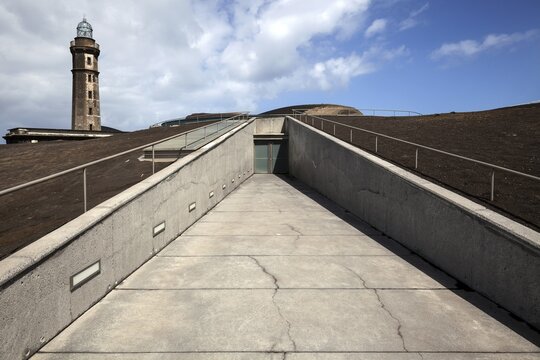 Entrance to the information centre Volcano Capelinhos, Centro de Interpretacao do Vulcao, back left old lighthouse at the Ponta dos Capelinhos, island of Faial, Azores, Portugal