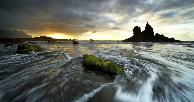 Dramatic cloud atmosphere with rock formation at sunset on the beach of Playa de Benijo, Canary Island, Tenerife, Spain