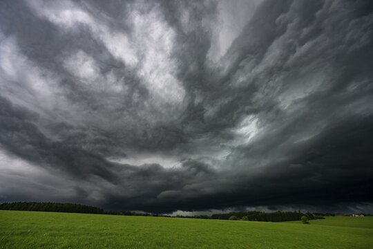 Road and meadows with thunderstorm sky in the background, Eggental, Ostallg&auml;u, Swabia, Bavaria, Germany