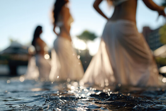 Soft light filters through splashes of water as dancers move in shallow water, conveying the essence of fluidity and elegance, enriched by the reflective surface beneath.