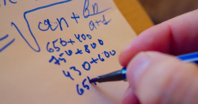 Close-up video of a marker writing numbers on a sheet of paper.