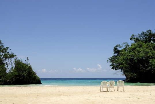 Isolated bay with three chairs, Rio Ochos, Jamaica, Caribbean, Central America