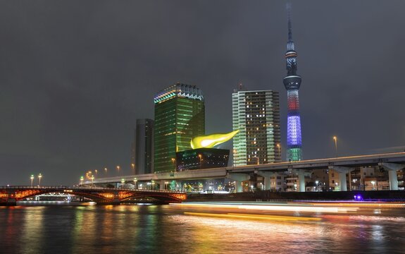 Night shot, Asahi Beer Hall, Asahi flame and Tokyo Skytree, skyscrapers at the river Sumida, Azumabashi, Tokyo, Japan