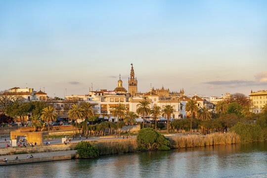 View over the river Rio Guadalquivir to the bullring Plaza de toros de la Real Maestranza de Caballer&iacute;a de Sevilla and bell tower La Giralda, sunset, Sevilla, Andalusia, Spain