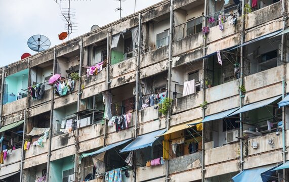 Derelict house facades with colourful laundry, Bangkok, Thailand