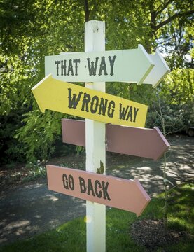 Curios sign post, That Way, Wrong Way, Go Back, Larnach Castle, Otago, New Zealand