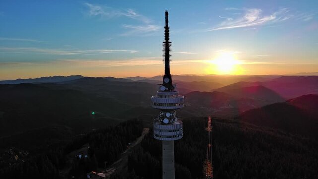 Tower Snezhana on peak of Snezhana covered with spruce forests in Rhodope mountains