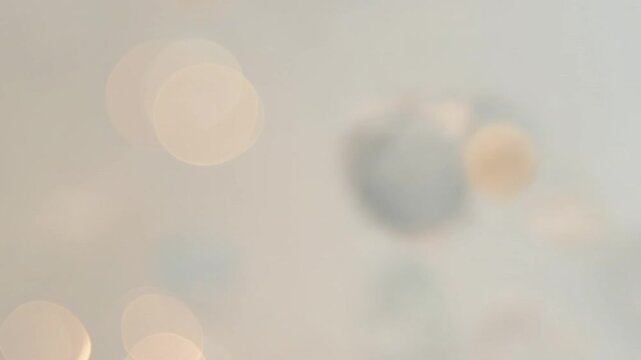 Soft pastel bokeh light background with dreamy defocused circles. Ideal for wedding videos, romantic projects, fashion visuals and elegant presentation backgrounds.