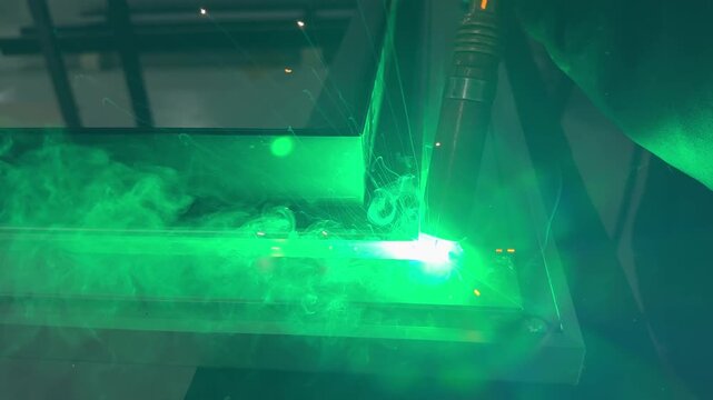 Macro shot of molten metal pool during professional argon welding procedure.