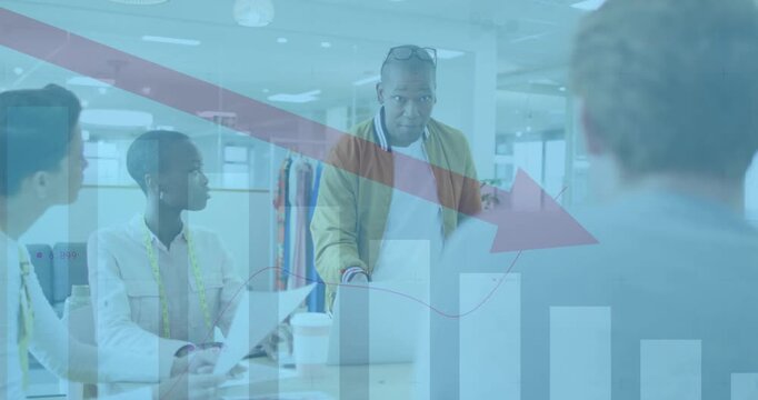 Presenter tapping laptop, guiding office meeting with red arrow bar chart fading in showing decline