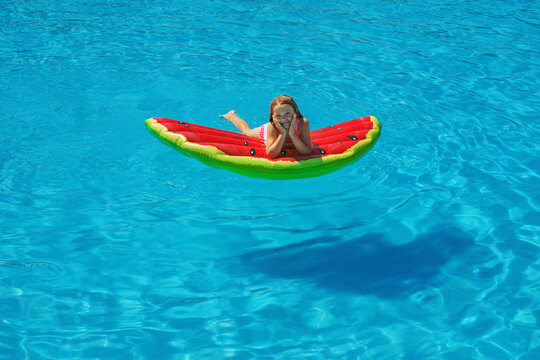 Child in swimming pool. Having fun on vacation at the hotel pool. Colorful vacation concept.