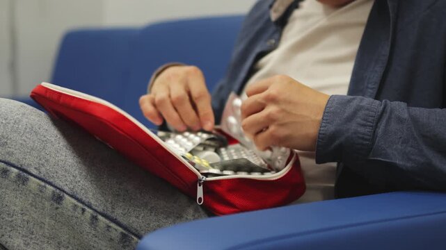 First aid kit. Sitting on the couch. Slow motion video. High quality 4k footage