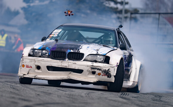 Riga, Latvia 2026-03-28  Racing car drifting on a dirt track with smoke effect