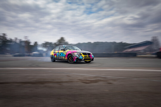 Riga, Latvia 2026-03-28  Vibrant Car Drifting on Asphalt Track
