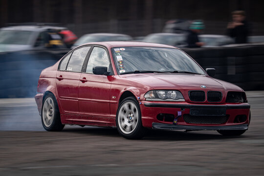 Riga, Latvia 2026-03-28  Red sports car drifting on a racetrack