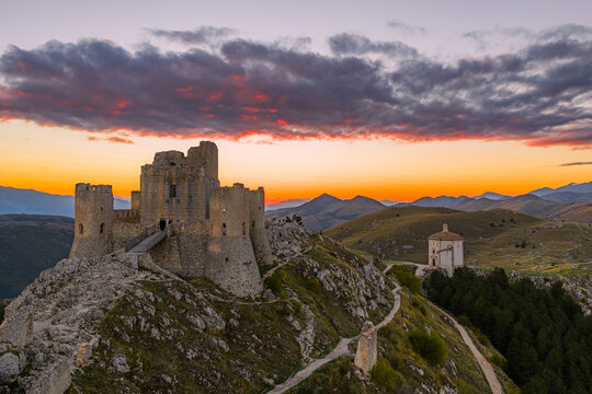 Aerial view of the medieval fortress of Rocca Calascio and the Santa Maria della Pieta church at sunset in Calascio, Abruzzo, Italy.