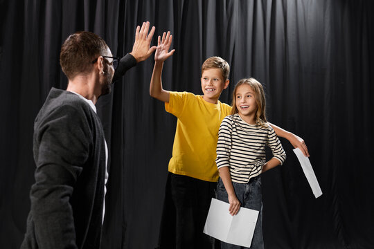 Engaging male tutor teaches young kids about theater skills and creativity in a vibrant space