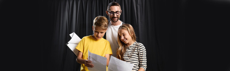 Engaging tutor inspires creativity in young actors during theater workshop session © LIGHTFIELD STUDIOS