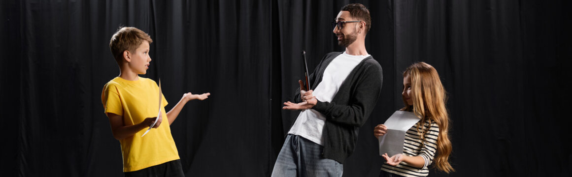 Exciting theater lesson with a stylish male tutor guiding young students in artistic expression