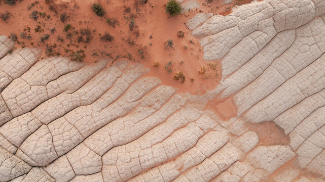 Aerial view of the unique brain-like sandstone formations and reddish desert sand at White Pocket in Coconino County, Arizona, United States.