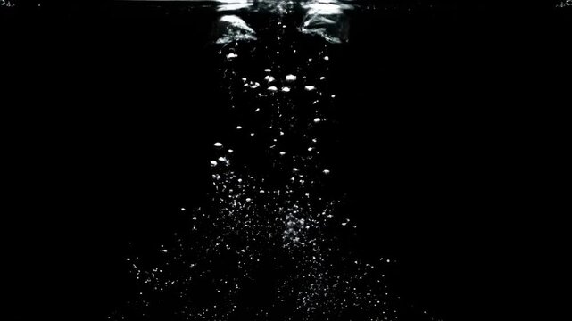 Three bubbles ascending with droplets against a black background