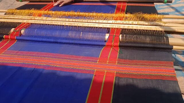 Loin loom weaver working in loom.	