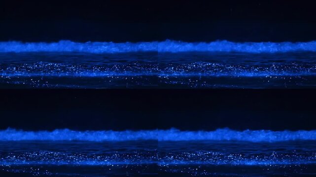 Two vibrant blue glowing horizontal lines filled with sparkling particles traversing a deep dark background, creating a futuristic and energetic abstract design.
