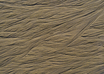 Abstract beach sand texture with flowing erosion lines © manuel