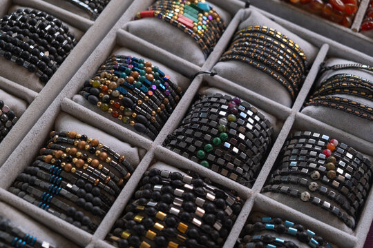 Colorful bracelets in display case for tourists to browse while visiting the beach area during the day