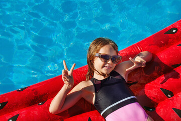 Child in swimming pool. Having fun on vacation at the hotel pool. Colorful vacation concept.