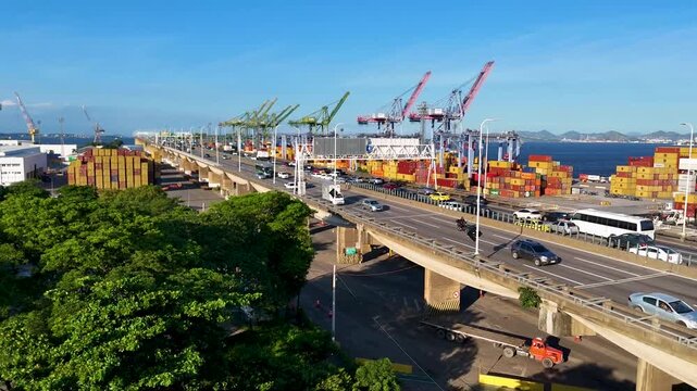 Aerial view of docks area full of containers loading to the ship in Rio de Janeiro city and the bridge crossing Guanabara bay