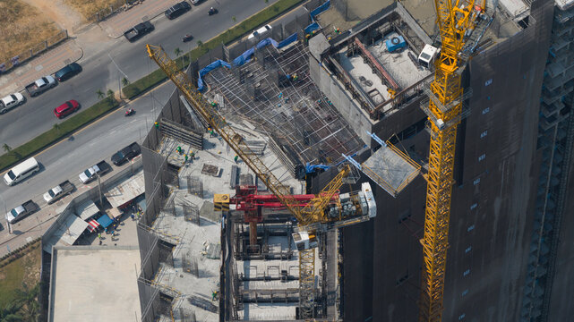 Copacabana, Thailand - 10 February 2026: Aerial view of the Copacabana Coral Reef residential building construction site, where cranes and workers work against the backdrop of the city's traffic.