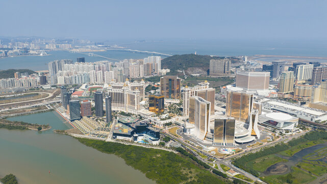 Taipa, Macao - 18 February 2026: Aerial view of golden casinos gleaming against the city's skyline, where luxury meets the horizon, framed by the vast ocean and verdant landscapes.