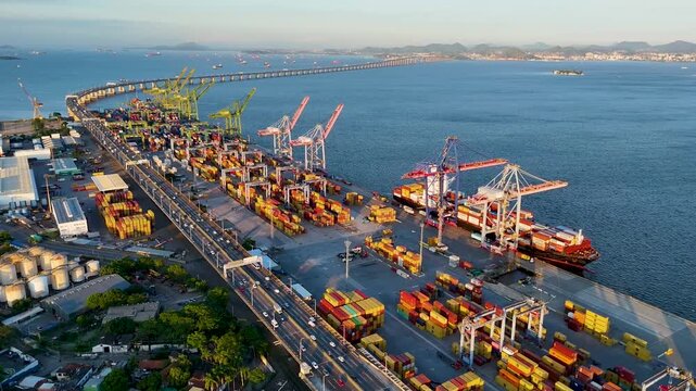 Aerial view of docks area full of containers loading to the ship in Rio de Janeiro city and the bridge crossing Guanabara bay