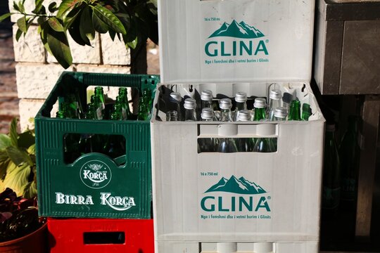 GJIROKASTER, ALBANIA - JULY 9, 2025: Korca Beer Albanian beer brand and Glina mineral water in plastic crate in Gjirokaster town in Albania.