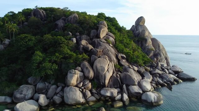 Aerial drone orbit around the unique coastal rocks of Hin Tha Toh in Koh Tao Thailand.