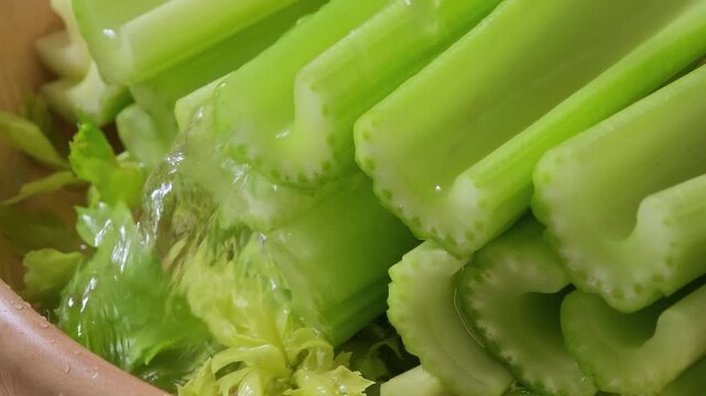Fresh celery in a wood bowl
