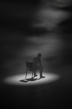 3D solitude spotlight chair with seated silhouette in shadow