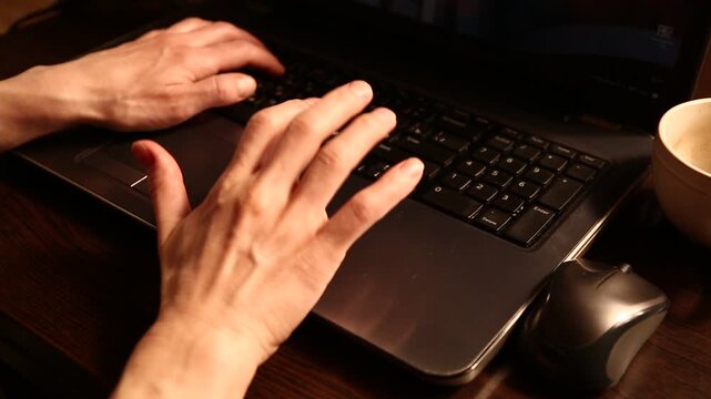 Business woman typing on keyboard the fingers, drinking coffee. Laptop placed on the wooden desk near coffee cup and computer wireless mouse. Closeup series of videos from different angles