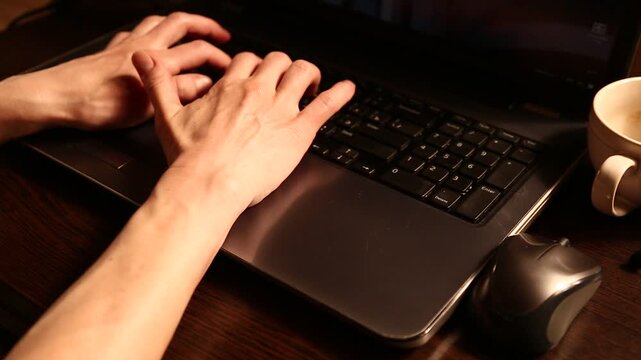 Business woman typing on keyboard the fingers, drinking coffee. Laptop placed on the wooden desk near coffee cup and computer wireless mouse. Closeup series of videos from different angles