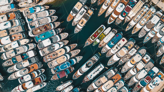 Aerial view of yachts nestled closely together, their hulls reflecting the sunlight in a dazzling display of colors, Jesenice, Split-Dalmatia County, Croatia.