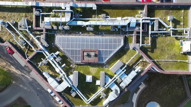 Modern energy-efficient house rooftop showcasing integrated utilities and pipes, with a gradual camera zoom out revealing the innovative design and sustainable features of the structure
