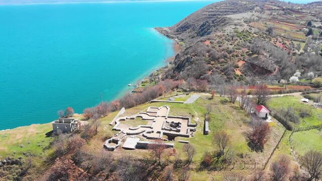 Village of Lin on the Rocky Peninsula Edge Along the Beautiful Shoreline of Lake Ohrid surrounded by emerald calm waters
