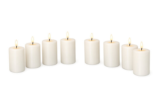 White candles with lit flames on transparent background