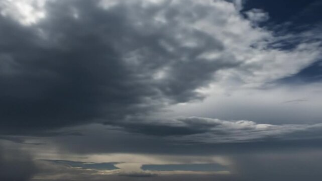 Dramatic clouds and rainstorm with dark and ominous sky in natural atmospheric daytime weather conditions
