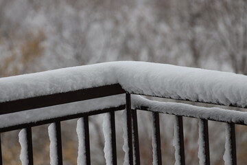 wet snow piled atop iron railings, clinging to uprights (macro, close-up, seasonal) © Don Hoskins